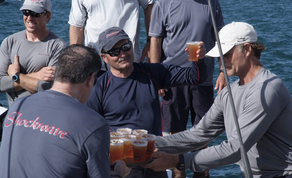 George Sakellaris, owner of the first to finish yacht Shockwave celebrates with Gosling's Dark 'n Stormy drink with his crew on arrival at the Royal Bermuda YC dock. Photo Barry Pickthall/PPL