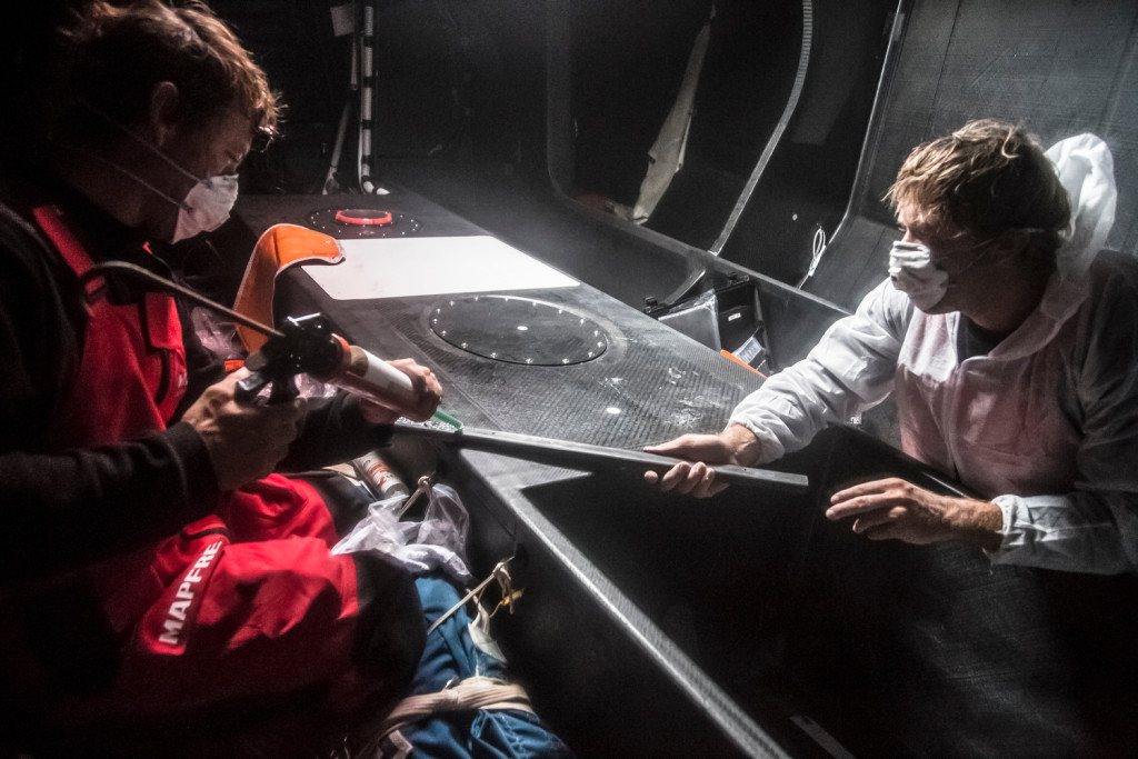 March 22, 2015. Leg 5 to Itajai onboard MAPFRE. Day 04. Skipper Iker Martinez glues on of the battens to stick to the hull (Francisco Vignale / MAPFRE / Volvo Ocean Race)