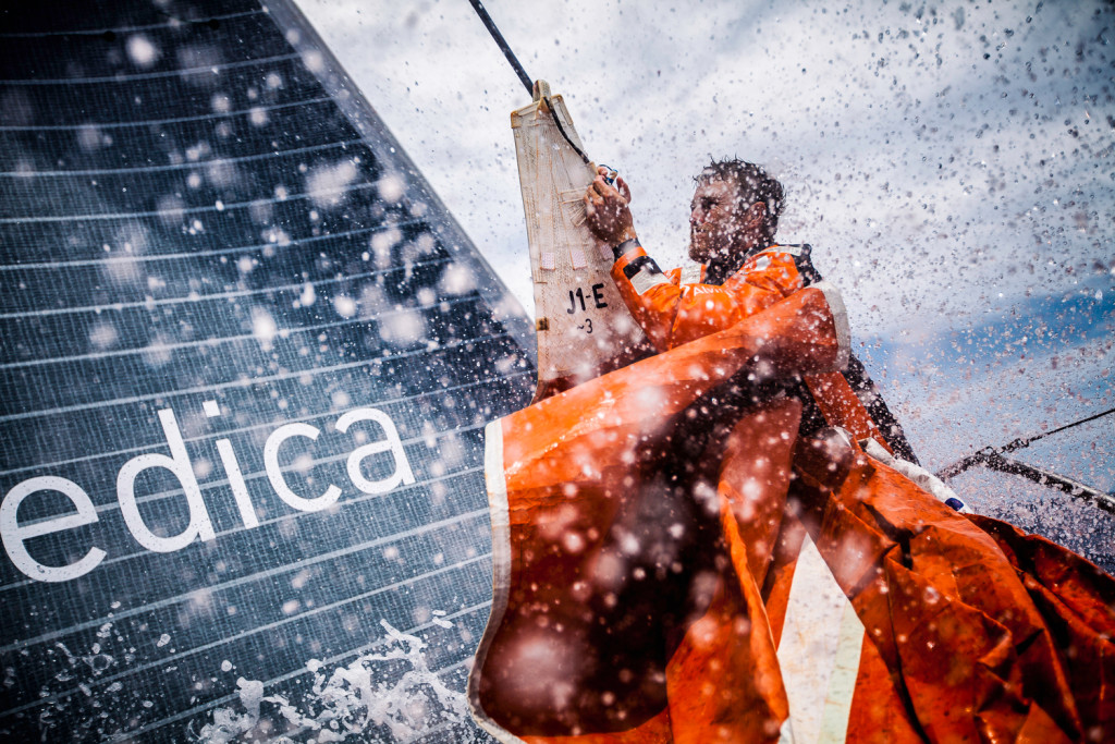 Leg 6 to Newport onboard Team Alvimedica. Day 15. Nick Dana finishes hanging on the J1 jib before peeling to the smaller sail in a building breeze. Through the cold front, it's back upwind in 15-20 knots north towards Newport and colder water, 750 miles away. (Amory Ross / Team Alvimedica / Volvo Ocean Race )