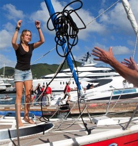 Dutch sailor Laura Dekker throws a rope as she docks her boat in Simpson Bay Marina in St. Maarten, Saturday Jan. 21, 2012. Dekker ended a yearlong voyage aboard her sailboat named "Guppy" that made her the youngest person ever to sail alone around the globe, although Guinness World Records and the World Sailing Speed Record Council did not verify the voyage, saying they no longer recognize records for youngest sailors to discourage dangerous attempts. (Photo by AP Photo/Stephan Kogelman)