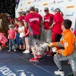 Groupama Sailing Team skipper Franck Cammas sprays champagne over winners CAMPER with Emirates Team New Zealand, skippered by Chris Nicholson from Australia, after the Auckland In-Port Race, during the Volvo Ocean Race 2011-12. (CPhoto by Ian Roman / Volvo Ocean Race)