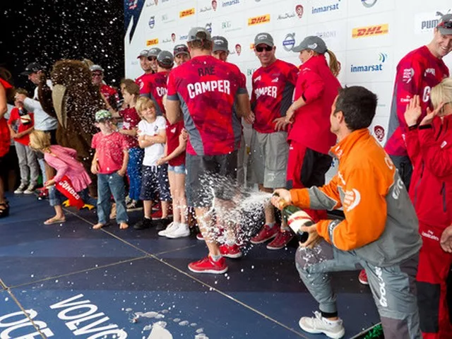 Groupama Sailing Team skipper Franck Cammas sprays champagne over winners CAMPER with Emirates Team New Zealand, skippered by Chris Nicholson from Australia, after the Auckland In-Port Race, during the Volvo Ocean Race 2011-12. (CPhoto by Ian Roman / Volvo Ocean Race)