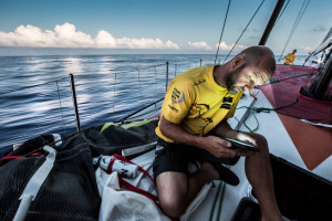 April 24, 2015. Leg 6 Newport onboard Abu Dhabi Ocean Racing. Day 5. Ian Walker looks at the nav computer to check positioning on the rest of the fleet as a front approaches in the sky. (Photo by Matt Knighton / Abu Dhabi Ocean Racing / Volvo Ocean Race)
